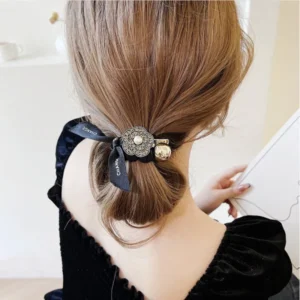 Woman wearing a black velvet hair scrunchie in her hair
