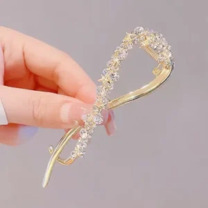 Stainless Steel Rhinestone Banana Hair Clip for Women Woman holding a stainless steel rhinestone banana hair clip between her fingers